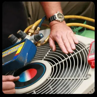 HVAC technician maintaining air conditioner