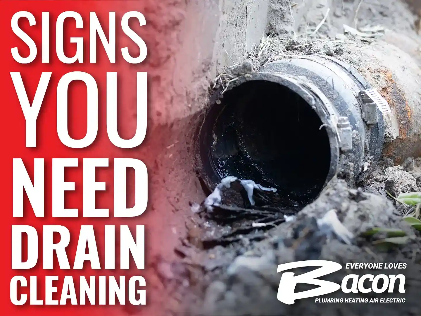 Close-up of a damaged, clogged outdoor drain pipe surrounded by dirt and debris, with the text 'Signs You Need Drain Cleaning' in bold white letters on a red background to the left.